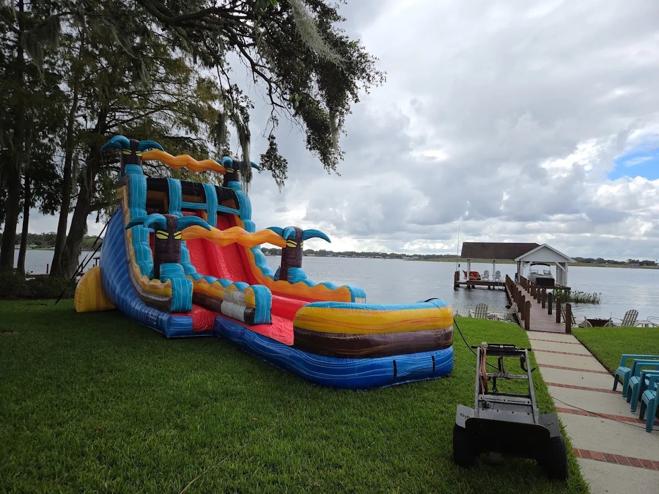 Kids enjoying an inflatable water slide at a backyard party